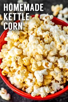 a red bowl filled with popcorn on top of a table