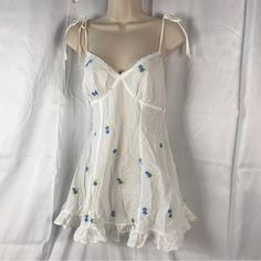 Vintage Y2k Victoria’s Secret Cotton Corset Back Slip Dress Condition Is Excellent Pricing Is Adjusted For The Rarity Of The Piece, And Condition. This Is Extremely Rare And Hard To Find Piece From Victoria’s Secret. Flounce Hem Fitted Darts Adjustable Straps Flirty Lace Up Corset Back Embroidered Satin Flowers In A Light Blue/ Lavender/Green Straps Have Ties For Accents On Shoulders Tiny Eyelet Lace Edges Size Is S 100% Lightweight Cotton This Cottagecore Slip Dress Is So Adorably Cute! Use As Victoria's Secret White Dress With Lace Trim, Victoria's Secret Spaghetti Strap Nightgown With Lace Trim, Coquette Night Slip Dress With Lace Trim, Corset Slip Dress, Lace Up Corset Back, Vintage Slip Dress With Lace Trim For Sleep, Vintage Victoria Secret Slip Dress, Cotton Corset, Lace Edges