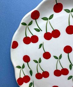 a plate with cherries painted on it