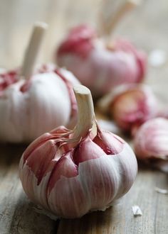 some garlic on a wooden table with other food items