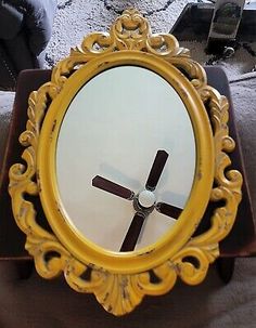 a mirror with a cross on it sitting on a table in front of a couch