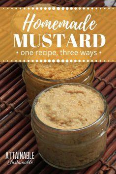 two jars filled with homemade mustard sitting on top of a bamboo mat next to cinnamon sticks