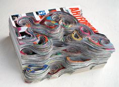 a stack of magazines sitting on top of a white table