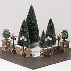 there is a miniature garden with trees and rocks