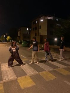 some people are crossing the street at night