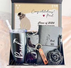 a gift box containing a personalized drink, keychain and other items