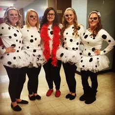 four women dressed up in costumes posing for the camera