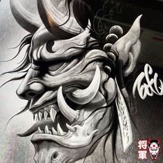 a drawing of a demon with horns and fangs on it's face is shown