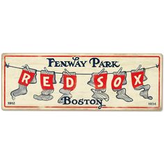 a red sox sign hanging from a clothes line with the words fenway park on it