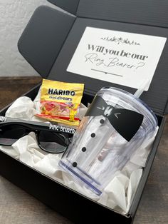 an open box with sunglasses, candy and other items