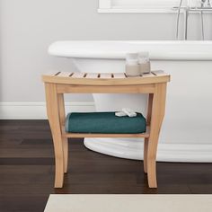 a bathroom with a sink, toilet and bathtub in the background that is white