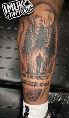 a man with a tattoo on his leg that says, god is my protector killer no one