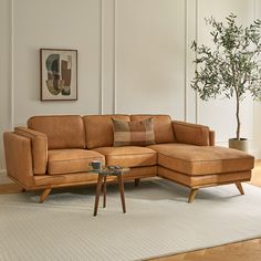 a living room with a sectional couch and coffee table