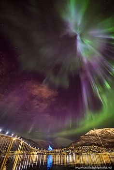 an aurora bore is seen over the water at night