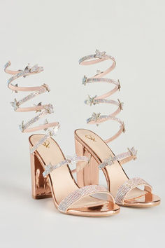 a pair of high heeled sandals with crystal straps