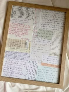 a wooden frame filled with lots of writing on top of a sheet of white paper