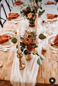 the table is set with candles, flowers and napkins for an elegant fall dinner