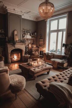 a living room filled with furniture and a fire place in the middle of the room