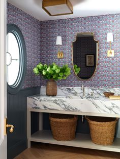 a bathroom with two sinks and baskets on the counter