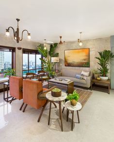 a living room filled with lots of furniture and plants on top of it's walls