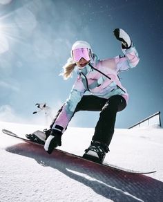 a woman riding skis down the side of a snow covered slope