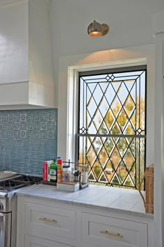 a kitchen with a stove top oven next to a window