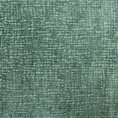 an upholstered green fabric textured with small squares