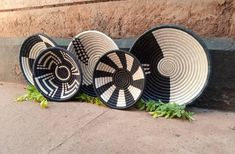 three black and white baskets sitting next to each other on the side of a building