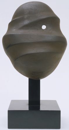 a sculpture is shown on a black stand