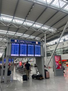 an airport terminal with people waiting for their luggage to arrive or leave the gate and check in