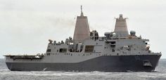 a large gray ship in the middle of the ocean