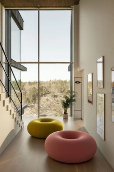 a living room filled with furniture and large windows