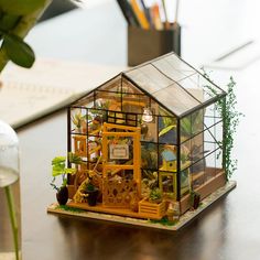 Cathy's Flower House is the most popular DIY miniature house kit ever! It mimics a well-designed transparent glass greenhouse, like a dream garden house in real! We are proud to introduce that our DIY cottage products are not only exquisite and lovely, but also have an amazing feature - they can light up! Whether you are creating, studying, or working, our cottages will create a space full of warmth and romance, making your life more beautiful! Once upon a time, in a magical flower house, lived a tiny fairy named Cathy.One sunny morning, when painting, Cathy discovered a withered rose. She was determined to revive it, whispering gentle words of love and caressing it with her wand. The rose immediately bloomed into the most beautiful flower in the garden. 231 pieces Approx. 16h to complete Miniature Greenhouse, Koti Diy, Flower House, Hari Valentine, Dollhouse Kits, Wooden Dollhouse, 3d Puzzles, Miniature Houses, Miniature House