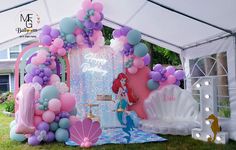 a little mermaid themed birthday party with balloons and decorations for the entrance to the tent