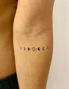 the back of a woman's arm with three phases on her left side, and two