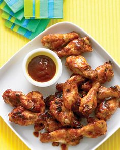 chicken wings on a plate with ketchup and mustard