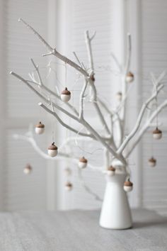 a white tree with ornaments hanging from it's branches