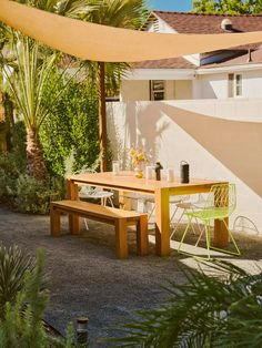 a wooden table sitting under a yellow awning