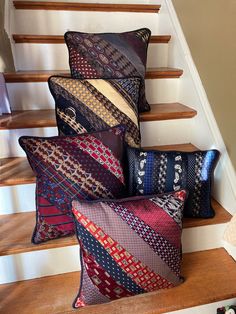 several pillows are stacked on top of each other in front of the stair railings