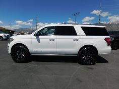 a white suv parked in a parking lot