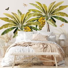 a bed sitting under a large banana tree mural