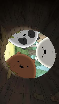 two pandas are peeking out from behind a hole