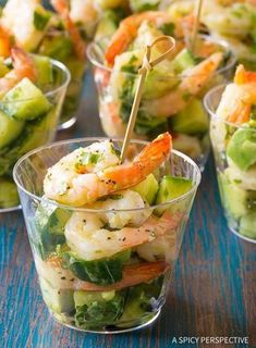 shrimp and cucumber salad in small cups with toothpicks on the top