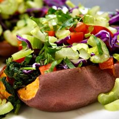 a plate with some food on it and lettuce, carrots, and other veggies