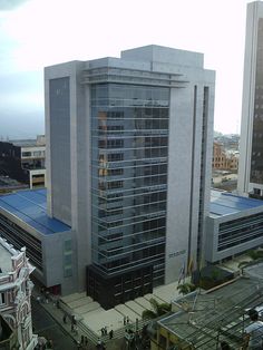 an aerial view of a city with tall buildings and people walking on the sidewalk in front of it