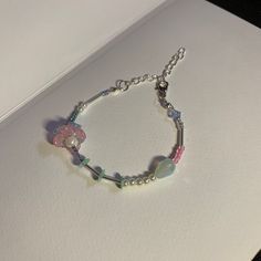 a bracelet with beads and flowers on it