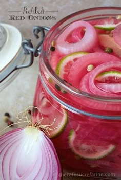 a jar filled with sliced up onions next to a onion