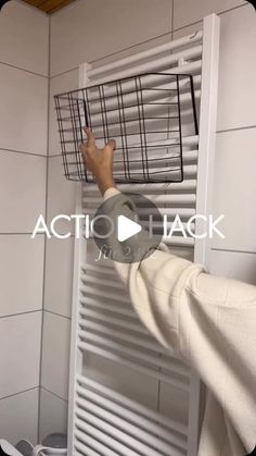 a person is holding a basket over the radiator in front of a tiled wall