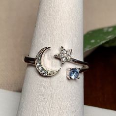 Dainty Sterling & Cz Crescent Moon And Star Ring, S925, Adjustable. With Light Blue And Clear Aaa+ Cz Colored Stones. Sterling Silver Marked S925. A Beautifully Made Ring. Nwot Ring Is Currently Sized At 6.25, But Can Be Adjusted To Fit Most. Makes A Great Gift For Daughter, Girlfriend, Wife, Mom, Christmas, Party, Holiday. A Great Item To Bundle And Save! . All Offers Considered. Silver Moon Shaped Diamond Ring, Moon Shaped Silver Diamond Ring, Crescent Moon And Star, Moon And Star Ring, Colored Stones, Mom Christmas, Gift For Daughter, Moon And Star, Star Ring