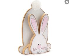 a wooden bunny with a pom - pom on it's head and ears